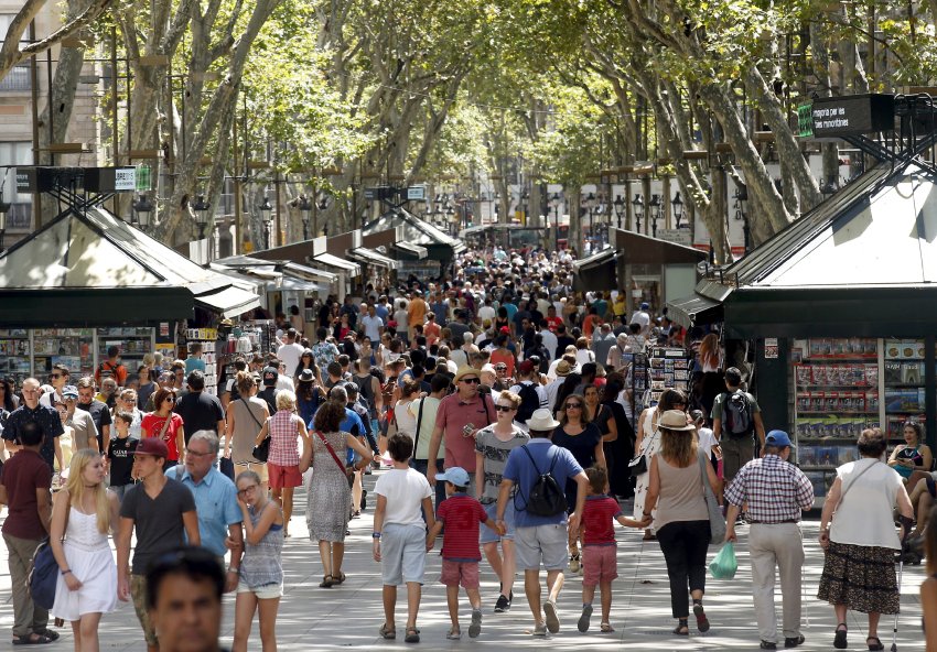 FILE PHOTO: People walk by Las Ramblas in Barcelona